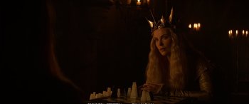 Movie still from “The Huntsman: Winter's War” (2016), directed by Cedric Nicolas-Troyan – A woman wearing a crown sitting in front of a chessboard; Close Up shot, Over the shoulder angle