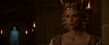 Movie still from “The Huntsman: Winter's War” (2016), directed by Cedric Nicolas-Troyan – A woman wearing a gold crown in a dark room; Close Up shot, Over the shoulder angle