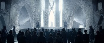 Movie still from “The Huntsman: Winter's War” (2016), directed by Cedric Nicolas-Troyan – A crowd of people standing in front of a stage; Wide shot, Over the shoulder angle