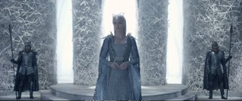 Movie still from “The Huntsman: Winter's War” (2016), directed by Cedric Nicolas-Troyan – A woman dressed in a white dress and a crown; Medium shot, Low angle