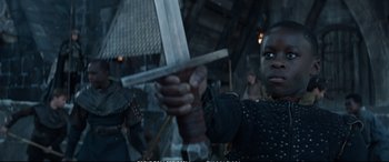 Movie still from “The Huntsman: Winter's War” (2016), directed by Cedric Nicolas-Troyan – A man holding a sword in front of a crowd of people; Close Up shot, Low angle