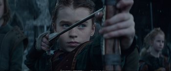 Movie still from “The Huntsman: Winter's War” (2016), directed by Cedric Nicolas-Troyan – A young boy holding a bow and arrow; Close Up shot, Over the shoulder angle