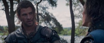 Movie still from “The Huntsman: Winter's War” (2016), directed by Cedric Nicolas-Troyan – A person wearing a costume near a body of water; Close Up shot, Over the shoulder angle