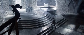 Movie still from “The Huntsman: Winter's War” (2016), directed by Cedric Nicolas-Troyan – A man sitting on a set of steps in a theater; Extreme Wide shot, High angle