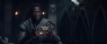 Movie still from “The Huntsman: Winter's War” (2016), directed by Cedric Nicolas-Troyan – A man in a leather jacket holding a crown; Close Up shot, Over the shoulder angle