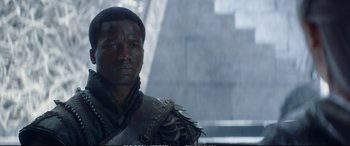 Movie still from “The Huntsman: Winter's War” (2016), directed by Cedric Nicolas-Troyan – A black man in a leather jacket looking to his left; Close Up shot, Over the shoulder angle