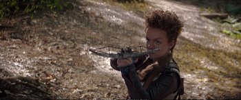 Movie still from “The Huntsman: Winter's War” (2016), directed by Cedric Nicolas-Troyan – A woman holding a crossbow up to her mouth; Medium shot, Over the shoulder angle