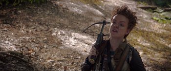 Movie still from “The Huntsman: Winter's War” (2016), directed by Cedric Nicolas-Troyan – A person holding a bow and arrow in a field; Medium shot, Over the shoulder angle