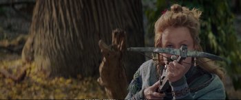 Movie still from “The Huntsman: Winter's War” (2016), directed by Cedric Nicolas-Troyan – A woman holding a bow and arrow in a forest; Medium shot, Over the shoulder angle