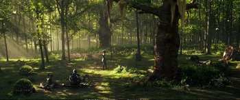 Movie still from “The Huntsman: Winter's War” (2016), directed by Cedric Nicolas-Troyan – Two people sitting in the middle of a lush green forest; Extreme Wide shot, High angle