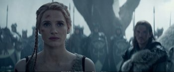 Movie still from “The Huntsman: Winter's War” (2016), directed by Cedric Nicolas-Troyan – A woman standing in front of a group of soldiers; Close Up shot, Over the shoulder angle