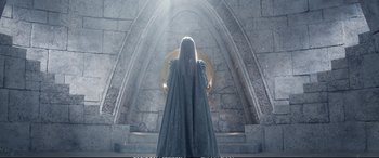 Movie still from “The Huntsman: Winter's War” (2016), directed by Cedric Nicolas-Troyan – A woman standing in front of a stone wall; Wide shot, Low angle