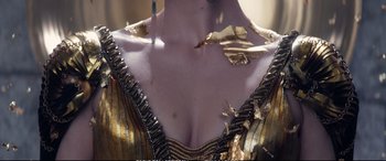 Movie still from “The Huntsman: Winter's War” (2016), directed by Cedric Nicolas-Troyan – View of the chest of a woman in a gold dress; Extreme Close Up shot, High angle