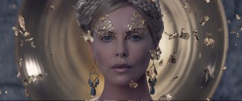 Movie still from “The Huntsman: Winter's War” (2016), directed by Cedric Nicolas-Troyan – A woman with gold face paint and earrings; Close Up shot, Overhead angle