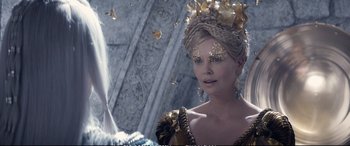 Movie still from “The Huntsman: Winter's War” (2016), directed by Cedric Nicolas-Troyan – A woman in a dress with a crown on her head; Close Up shot, Over the shoulder angle