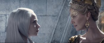 Movie still from “The Huntsman: Winter's War” (2016), directed by Cedric Nicolas-Troyan – Two women are facing each other in a stone wall; Close Up shot, Over the shoulder angle