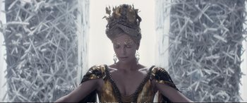 Movie still from “The Huntsman: Winter's War” (2016), directed by Cedric Nicolas-Troyan – A woman in a gold and black dress and a crown; Close Up shot, Overhead angle