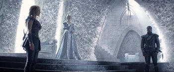 Movie still from “The Huntsman: Winter's War” (2016), directed by Cedric Nicolas-Troyan – A woman dressed as a snow queen standing in front of a stone wall; Wide shot, Low angle