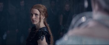 Movie still from “The Huntsman: Winter's War” (2016), directed by Cedric Nicolas-Troyan – A person with long red hair; Close Up shot, Over the shoulder angle