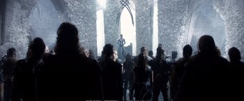 Movie still from “The Huntsman: Winter's War” (2016), directed by Cedric Nicolas-Troyan – A group of people standing in front of an audience; Wide shot, Over the shoulder angle
