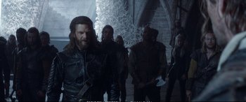 Movie still from “The Huntsman: Winter's War” (2016), directed by Cedric Nicolas-Troyan – A group of people standing around in a room; Medium shot, Low angle