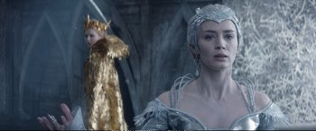 Movie still from “The Huntsman: Winter's War” (2016), directed by Cedric Nicolas-Troyan – A woman in a silver dress and a man in a gold costume; Close Up shot, Low angle