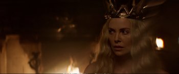 Movie still from “The Huntsman: Winter's War” (2016), directed by Cedric Nicolas-Troyan – A woman wearing a crown in front of a fire; Close Up shot, Over the shoulder angle