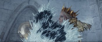 Movie still from “The Huntsman: Winter's War” (2016), directed by Cedric Nicolas-Troyan – A woman in a crown and a black and white dress; Medium shot, Low angle