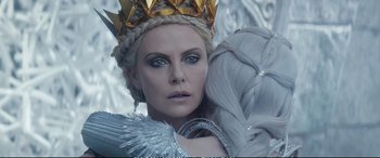 Movie still from “The Huntsman: Winter's War” (2016), directed by Cedric Nicolas-Troyan – A person wearing a crown and holding a bird; Close Up shot, Over the shoulder angle