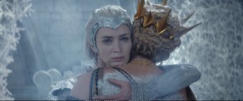 Movie still from “The Huntsman: Winter's War” (2016), directed by Cedric Nicolas-Troyan – A woman in a silver dress holding another woman in a white dress; Close Up shot, Over the shoulder angle