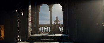 Movie still from “The Huntsman: Winter's War” (2016), directed by Cedric Nicolas-Troyan – A woman dressed in medieval clothing standing on a balcony; Wide shot, Low angle