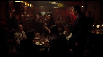 Movie still from “The Irishman” (2019), directed by Martin Scorsese – A group of people sitting at a table in a restaurant; Wide shot, High angle