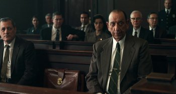 Movie still from “The Irishman” (2019), directed by Martin Scorsese – An old man sitting in a court room with other people; Medium shot, Over the shoulder angle