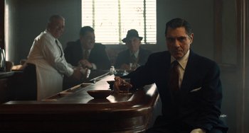 Movie still from “The Irishman” (2019), directed by Martin Scorsese – A group of men sitting at a table in front of a window; Medium shot, Over the shoulder angle