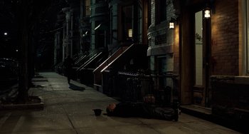 Movie still from “The Irishman” (2019), directed by Martin Scorsese – A man laying on the ground on the sidewalk; Wide shot, High angle