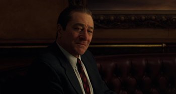 Movie still from “The Irishman” (2019), directed by Martin Scorsese – A person wearing a suit and tie; Close Up shot, Over the shoulder angle