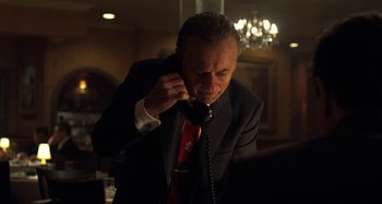 Movie still from “The Irishman” (2019), directed by Martin Scorsese – A man in a suit and tie on the phone; Close Up shot, Low angle