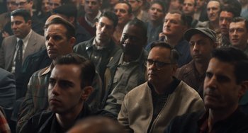 Movie still from “The Irishman” (2019), directed by Martin Scorsese – A crowd of people sitting in a room; Medium shot, High angle