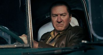 Movie still from “The Irishman” (2019), directed by Martin Scorsese – A person wearing a leather jacket; Close Up shot, Low angle