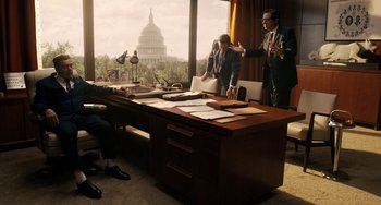 Movie still from “The Irishman” (2019), directed by Martin Scorsese – Two men are standing in front of an office desk; Wide shot, Over the shoulder angle