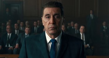 Movie still from “The Irishman” (2019), directed by Martin Scorsese – A person wearing a suit and tie; Close Up shot, Low angle