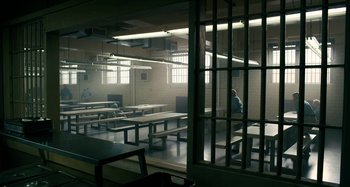 Movie still from “The Irishman” (2019), directed by Martin Scorsese – A man standing in a room with a bunch of tables; Extreme Wide shot, High angle