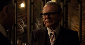 Movie still from “The Irishman” (2019), directed by Martin Scorsese – An older man wearing a suit and tie; Close Up shot, Over the shoulder angle