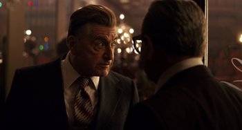 Movie still from “The Irishman” (2019), directed by Martin Scorsese – A man in a suit and tie talking to another man in a suit and tie; Close Up shot, Over the shoulder angle