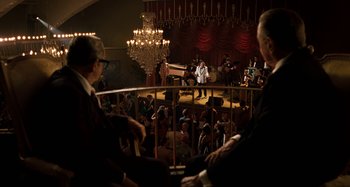 Movie still from “The Irishman” (2019), directed by Martin Scorsese – A group of people sitting in front of an audience; Wide shot, Over the shoulder angle