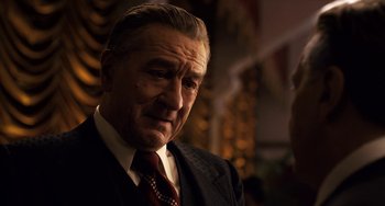 Movie still from “The Irishman” (2019), directed by Martin Scorsese – An older man wearing a suit and tie; Close Up shot, Over the shoulder angle