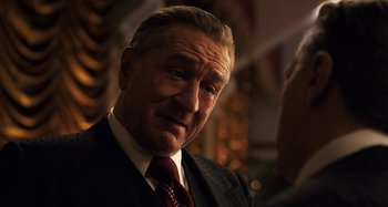 Movie still from “The Irishman” (2019), directed by Martin Scorsese – An older man wearing a suit and a tie; Close Up shot, Over the shoulder angle