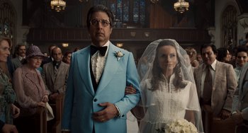 Movie still from “The Irishman” (2019), directed by Martin Scorsese – A man and a woman standing in front of each other in a church; Medium shot, Low angle