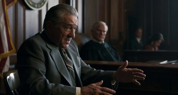 Movie still from “The Irishman” (2019), directed by Martin Scorsese – A man in a suit sitting in front of a judge; Medium shot, Over the shoulder angle
