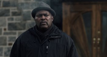 Movie still from “The Irishman” (2019), directed by Martin Scorsese – A man wearing a hat and a black jacket; Close Up shot, Low angle